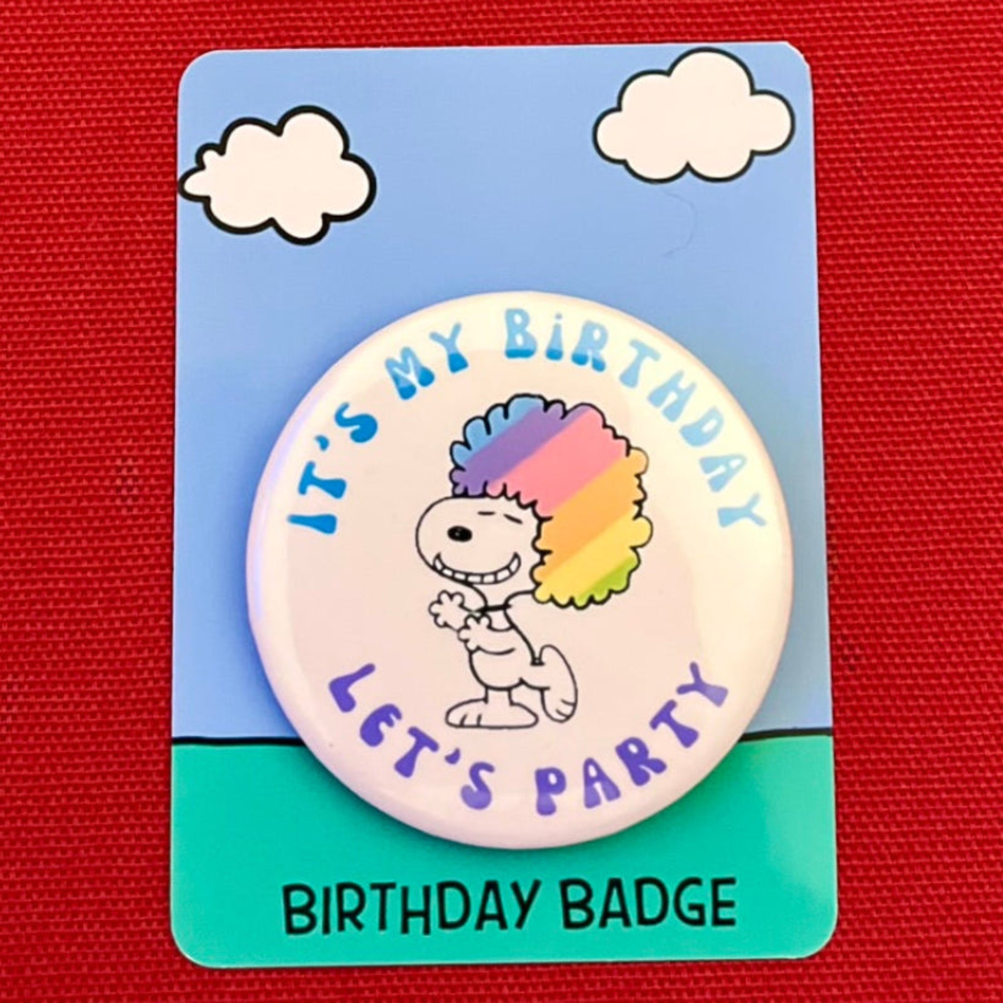 A birthday badge featuring a cartoon character with a rainbow-colored afro hairstyle and the text "It's my birthday let's party" on it.